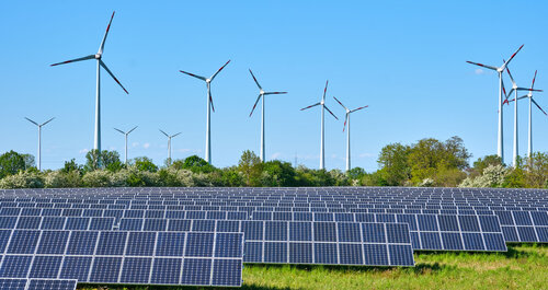 solar panles and wind turbines in the background